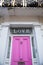 Word Love above the pink door of a white British house