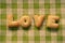 Word LOVE alphabet cookies Biscuits on plaid pattern with retro