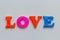 The word LOVE of colored magnetic letters on the learning Board.