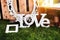 The word love composed of white letters on the sunset. Decoration proposal. Planning of wedding, celebrations in exterior.