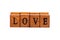 Word LOVE isolated, wooden letter rubber stamps font closeup, on white, cut out. Simple love concept text element, letters