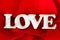 Word Love with rose petals. Sweet holiday background. Valentines Day Card.