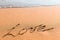 Word LOVE on sand