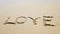 Word love on the sand that wiped off