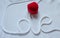 Word `love` written with white cord and red heart jewel  case.