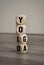 Word made of wooden blocks, cubes and dice with yolo and yoga