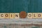 Word made of wooden letters and old brown coin