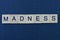 word madness from gray wooden letters