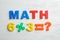 Word MATH and equation of magnetic letters on wooden background