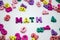 Word `math` is laid out of wooden multicolored letters