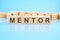 word Mentor made with wood building blocks, business concept