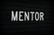 The word Mentor on a Notice Board