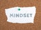 The word mindest is standing on a paper, pin board, coaching concept, changing believes, starting