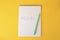 Word Mistake written with erasable pen in notepad on yellow background, top view