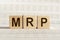 The word MRP Abbreviation of Material requirements planning on wooden cubes on white background