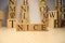 The word nice was created from wooden letter cubes. Cities and words.