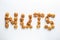 Word NUTS made of walnut on white background