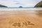 Word NZ hashtag written in sand on New Zealand beach for social media following online advertisement concept. Abel
