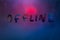word offline handwrittern on foggy glass with cold neon blue back light