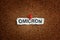 The word Omicron on a piece of paper that is pinned to a cork board