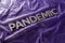The word pandemic laid with silver metal letters on crumpled violet protective plastic film background in slanted
