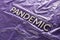Word pandemic laid with white brushed metal characters over crumpled violet protective plastic film backdrop in slanted