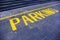 The word `parking` painted in yellow