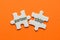 The word Partnership on two matching puzzle on orange background