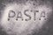 The word & x27;pasta& x27; from flour. Banner. talian pasta, flat lay close-up