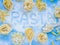 Word Pasta on wooden table with variety of types and shapes of dry Italian pasta and flour. Pasta ingredients on wooden