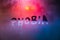 the word phobia handwritten on wet foggy window glass surface with red-blue background lights