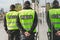 Word police written on reflective vests of police officers