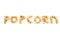 The word POPKORN is laid out from pieces of caramel popcorn on a white background.