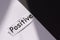Word positive written on white paper . The concept of positive