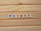 Word Poverty on wood