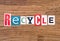 Word `recycle` on wooden background