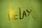 Word relax written on a fogged bathroom window in partial blur