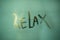 Word relax written on a fogged bathroom window in partial blur