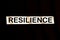 The word resilience on a black background.Concept of overcoming barriers and resilience