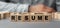 The word Resume made from wooden cubes. Selective focus