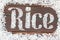 The word rice written letters of rice on a wooden board