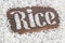 The word rice written letters of rice on a wooden board