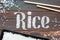 The word rice written letters of rice on a wooden board