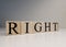 The word right from wooden cubes. Spot light and white background. Close up