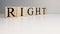The word right from wooden cubes. Spot light and white background. Close up