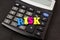 The word `risk` from the letters lies on the calculator. Close-up. The concept of business risk, economic crisis.