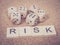 Word RISK in wooden block and dices