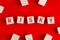 The word risky written on wooden blocks on red background. Concept of risk management or assessment and decision making in an