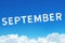 Word September made of clouds steam on blue sky background. Month planning, timetable concept.