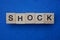Word shock made from brown wooden letters